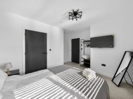 A bedroom with a bed and television at Heddfan in Carmarthen