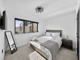 A bedroom with a bed and nightstand at Heddfan in Carmarthen