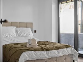 A bedroom with a bed and towels at Heddfan in Carmarthen