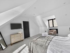 A bedroom with a bed and a television at Heddfan in Carmarthen