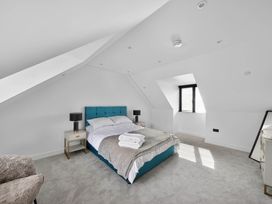 A bedroom with a bed and bedside table at Heddfan in Carmarthen