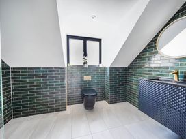 A bathroom with a toilet and sink at Heddfan in Carmarthen
