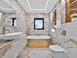 A bathroom with a bathtub and sink at Heddfan in Carmarthen