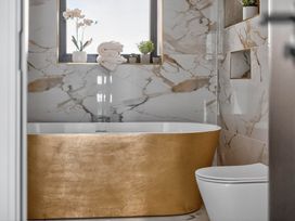 A bathroom featuring a bathtub and toilet at Heddfan in Carmarthen