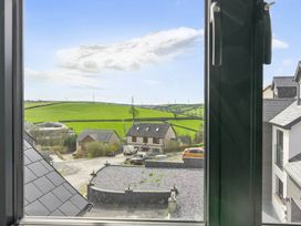 A view from a window showing countryside with houses and a road at Heddfan in Carmarthen