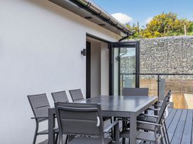 An outdoor space with a table and chairs at Heddfan in Carmarthen