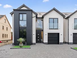 A modern house with a garage and large windows at Ty Uchel 