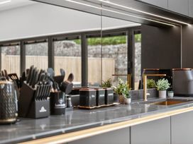 A kitchen with a sink and utensils at Ty Uchel