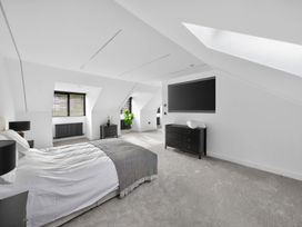 A bedroom with a bed and a dresser at Ty Uchel 