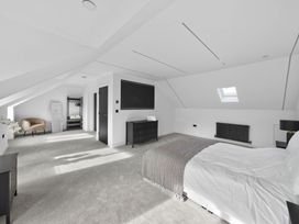 A bedroom with a bed and dresser at Ty Uchel