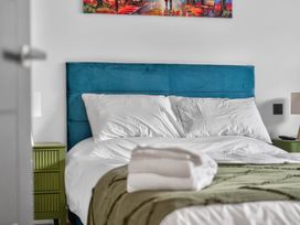 A bedroom with a bed and bedside tables at Ty Uchel