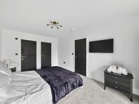 A bedroom with a bed and television at Ty Uchel