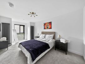 A bedroom with a bed and side tables at Ty Uchel