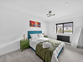 A bedroom with a bed and bedside tables at Ty Uchel