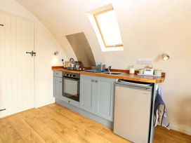 A kitchen with oven and fridge at Grape Escape near Halesworth
