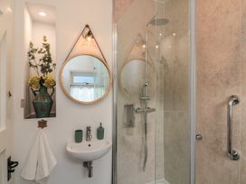 A bathroom with shower and sink at Ivy Cottage in Dartmouth