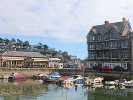 Boats in water near a building at Ivy Cottage Dartmouth