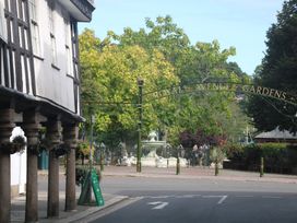 A street view with a building and trees at Ivy Cottage in Dartmouth