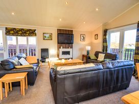 A living room with a sofa and coffee table at Kingfisher Lodge