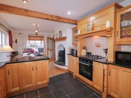 A kitchen with wooden cabinets and appliances at Bungalow Falcarragh in Falcarragh, County Donegal