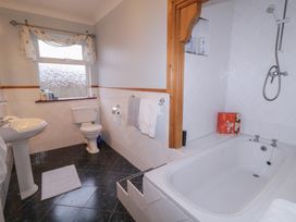A bathroom with a bathtub, sink, and toilet at Bungalow Falcarragh, Falcarragh, County Donegal