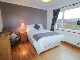 A bedroom with a bed and nightstand at Bungalow Falcarragh in Falcarragh, County Donegal