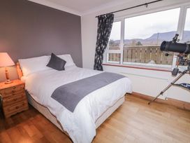 A bedroom with a bed and telescope at Bungalow Falcarragh, Falcarragh, County Donegal