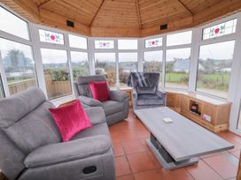 A conservatory with a sofa and recliner at Bungalow Falcarragh in Falcarragh, County Donegal