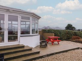 A conservatory with steps leading to a patio area at Bungalow Falcarragh in Falcarragh, County Donegal