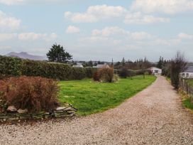 A gravel path leading to a house surrounded by grass and hedges at Bungalow Falcarragh in Falcarragh, County Donegal