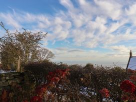 A view of clouds and bushes with flowers at Cheyne Cottage in Fylingthorpe