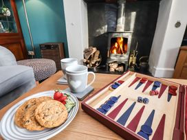 A living room with a backgammon board and cookies at Cheyne Cottage in Fylingthorpe