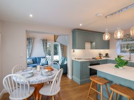 A kitchen with a table and chairs at Cheyne Cottage in Fylingthorpe