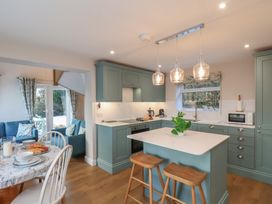 A kitchen with stools and table at Cheyne Cottage in Fylingthorpe
