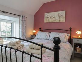 A bedroom with a bed and a window at Cheyne Cottage in Fylingthorpe