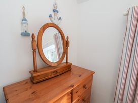 A dresser with a mirror at Cheyne Cottage in Fylingthorpe