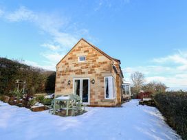 A house with snow in the garden at Cheyne Cottage in Fylingthorpe