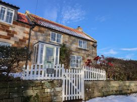A house with a gate and fence at Cheyne Cottage in Fylingthorpe