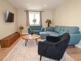 A living room with a sofa, coffee table, and television at 3 Rope Walk St. Austell