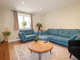 A living room with a blue sofa and a coffee table at 3 Rope Walk, St. Austell