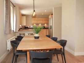 A dining room with a wooden table and chairs at 3 Rope Walk in St. Austell