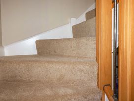 A staircase with carpet leading to a landing at 3 Rope Walk St. Austell