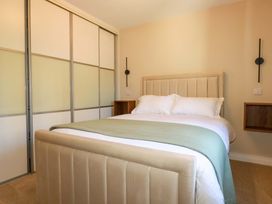 A bedroom with a bed and wardrobe at 3 Rope Walk in St. Austell