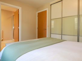 A bedroom with a bed and wardrobe at 3 Rope Walk in St. Austell