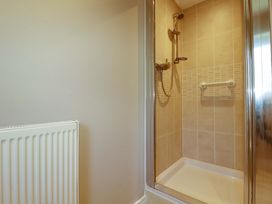 A shower area with a showerhead and grab bar at 3 Rope Walk St. Austell