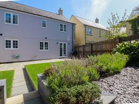 A garden with a house and pathways at Trelawney House Duporth near Charlestown