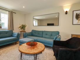 A living room with a sofa and coffee table at Trelawney House in Duporth near Charlestown
