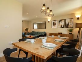 A dining room with a table set for meals at Trelawney House in Duporth near Charlestown