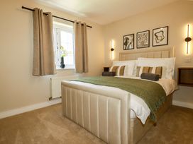 A bedroom featuring a bed and window at Trelawney House Duporth near Charlestown