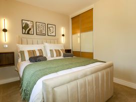 A bedroom with a bed and bedside tables at Trelawney House in Duporth near Charlestown